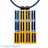 Pendant made with gold and dark silver LEGO® bricks inspired by the New York skyline. HIGH-RISE pendant No. 2.