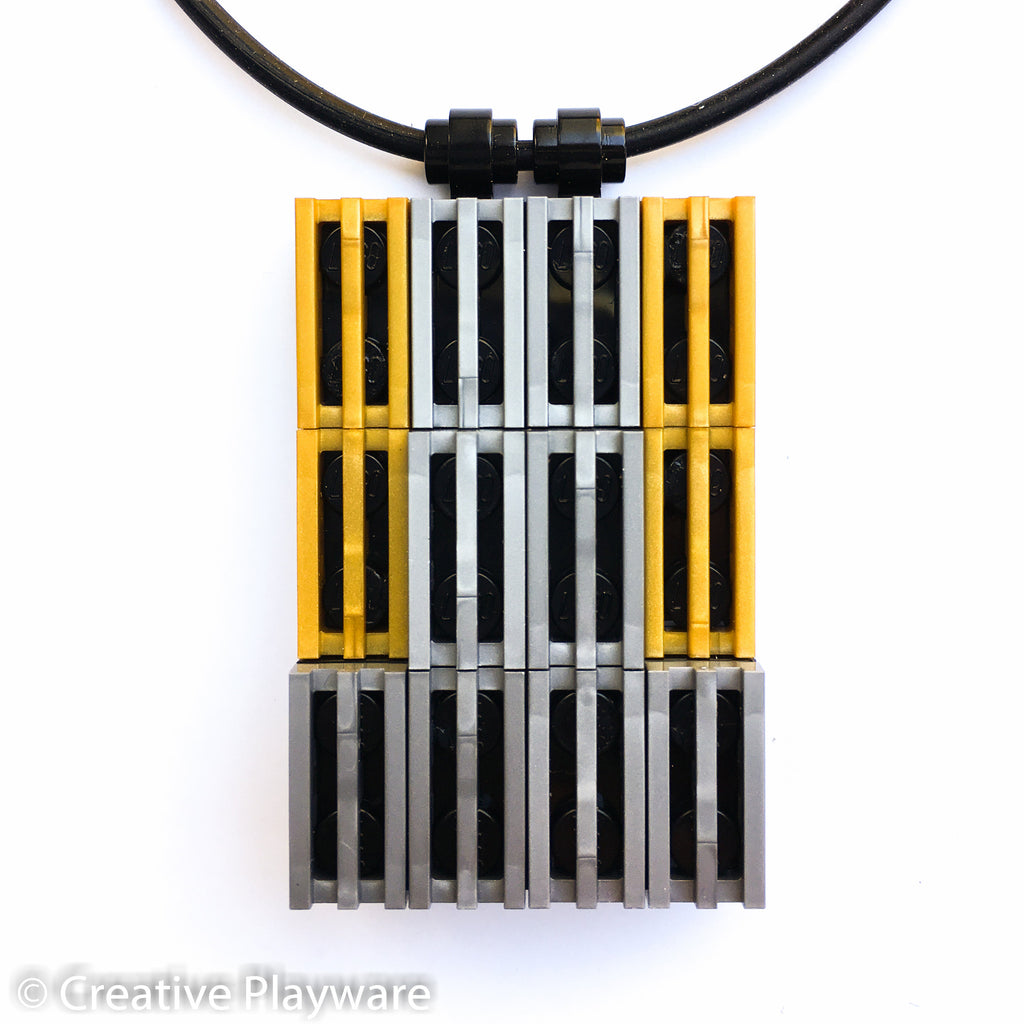 Pendant in gold and silver LEGO® bricks inspired by the New York skyline. HIGH-RISE pendant No. 1.