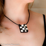 Escher-inspired pendant made with LEGO® elements